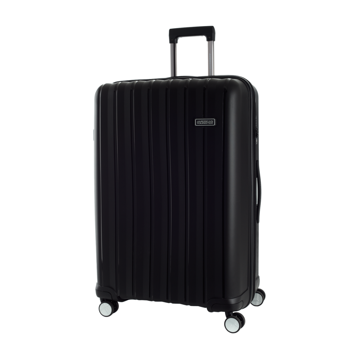 A black hard-shell spinner suitcase with a telescoping handle extended, shown on a plain white background. The suitcase features vertical grooves, four multi-directional spinner wheels, and a small silver brand plaque on the upper right side.AMERICAN TOURISTER.